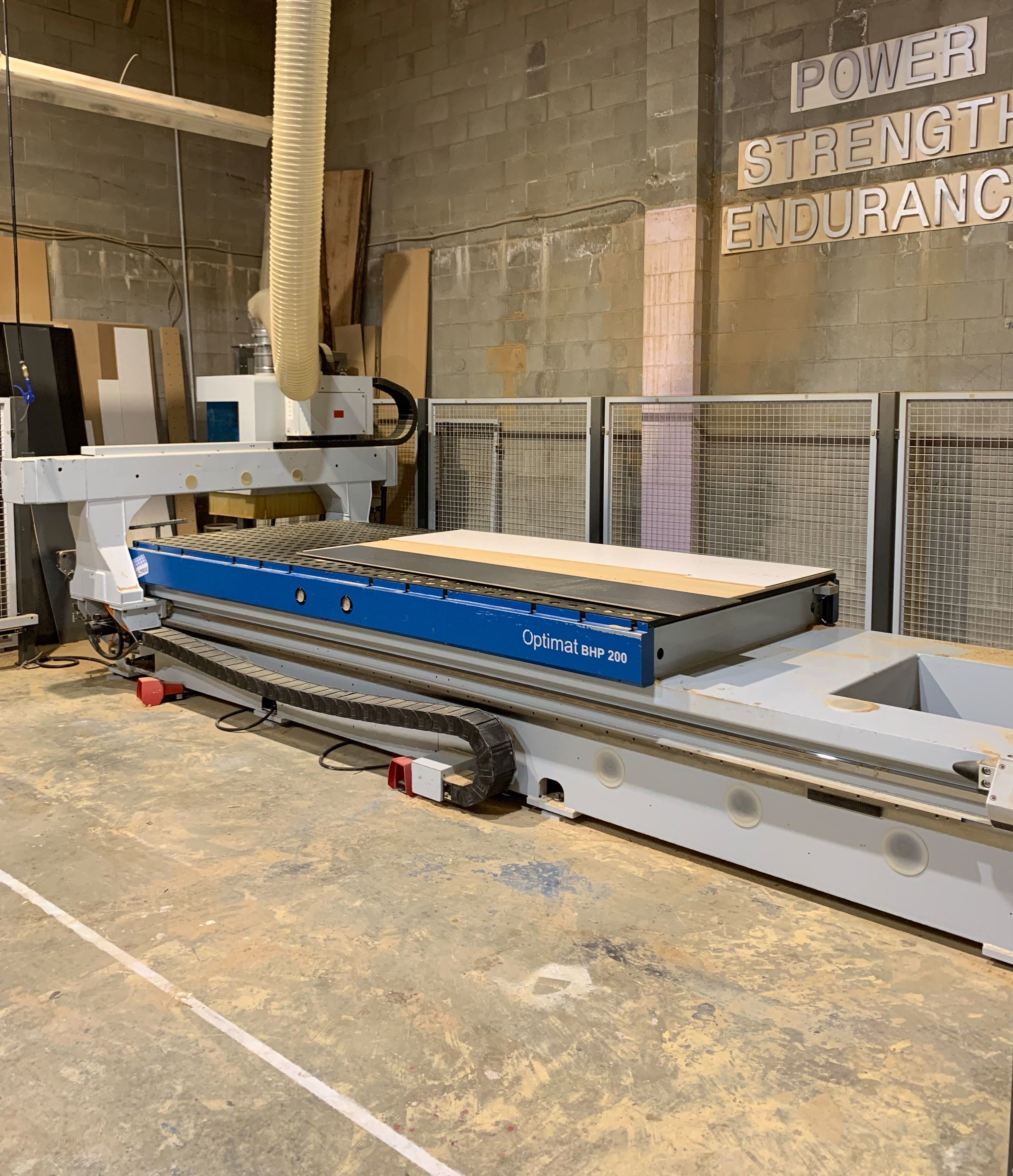 CNC precision cutting machine at work on wood panel